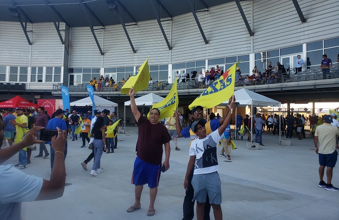 Prairie Fans 700 A group of people holding flags in the air.